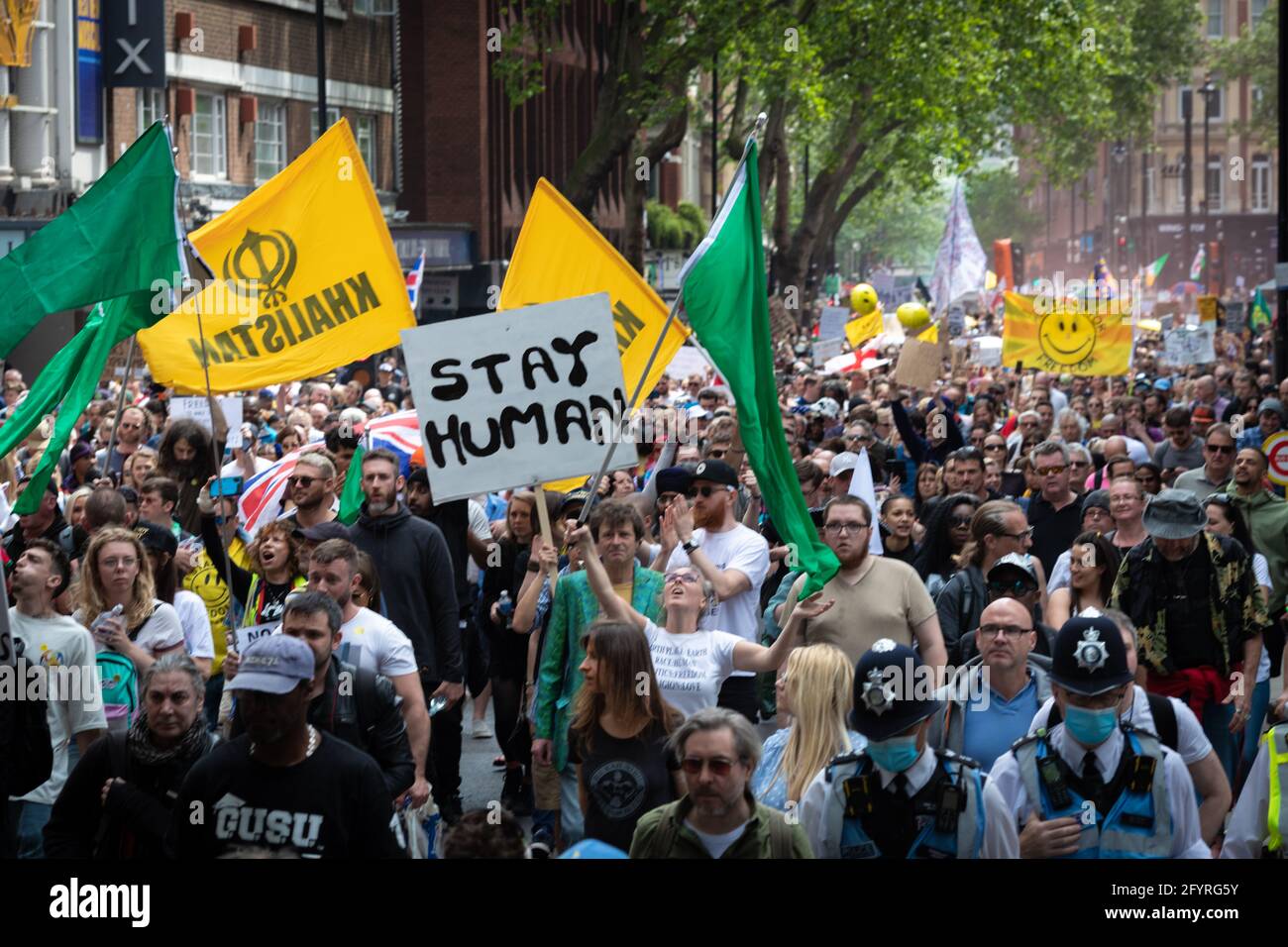 Manchester, UK. 29th May, 2021. Protesters march through the city during an anti-lockdown protest. The number of people attending the protests has increased month on month since the introduction of the COVID-19 restrictions. Credit: Andy Barton/Alamy Live News Stock Photo