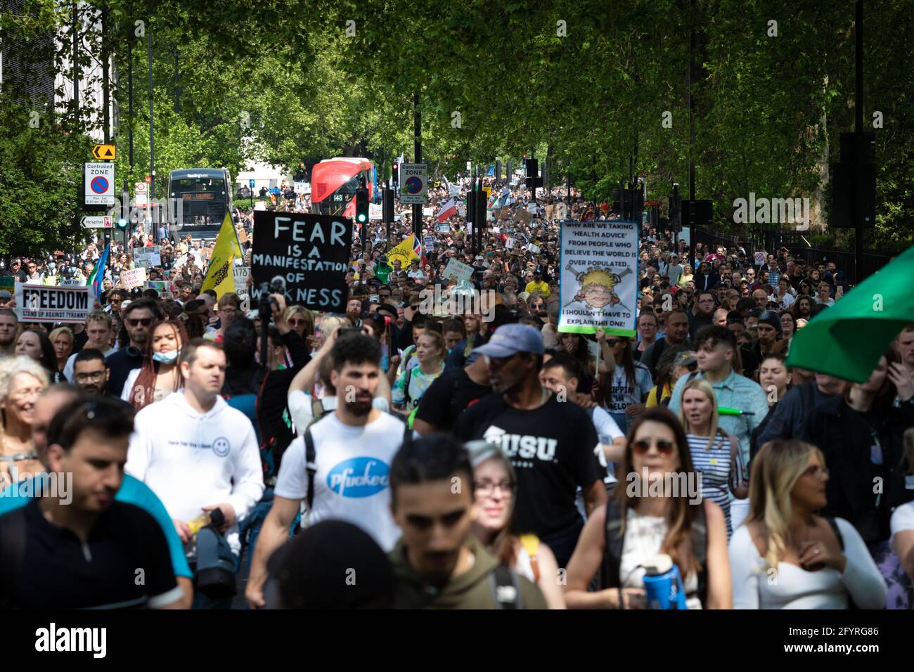 Manchester, UK. 29th May, 2021. Protesters march through the city during an anti-lockdown protest. The number of people attending the protests has increased month on month since the introduction of the COVID-19 restrictions. Credit: Andy Barton/Alamy Live News Stock Photo