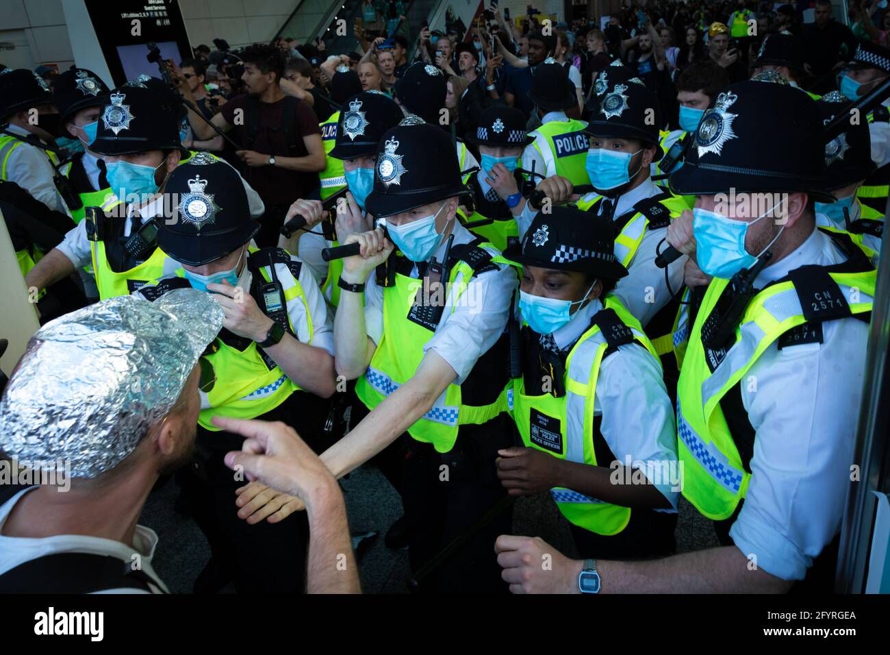 Manchester, UK. 29th May, 2021. The police hold back protesters from storming the Westfield shopping centre during a anti-lockdown protest. The number of people attending the protests has increased month on month since the introduction of the COVID-19 restrictions. Credit: Andy Barton/Alamy Live News Stock Photo