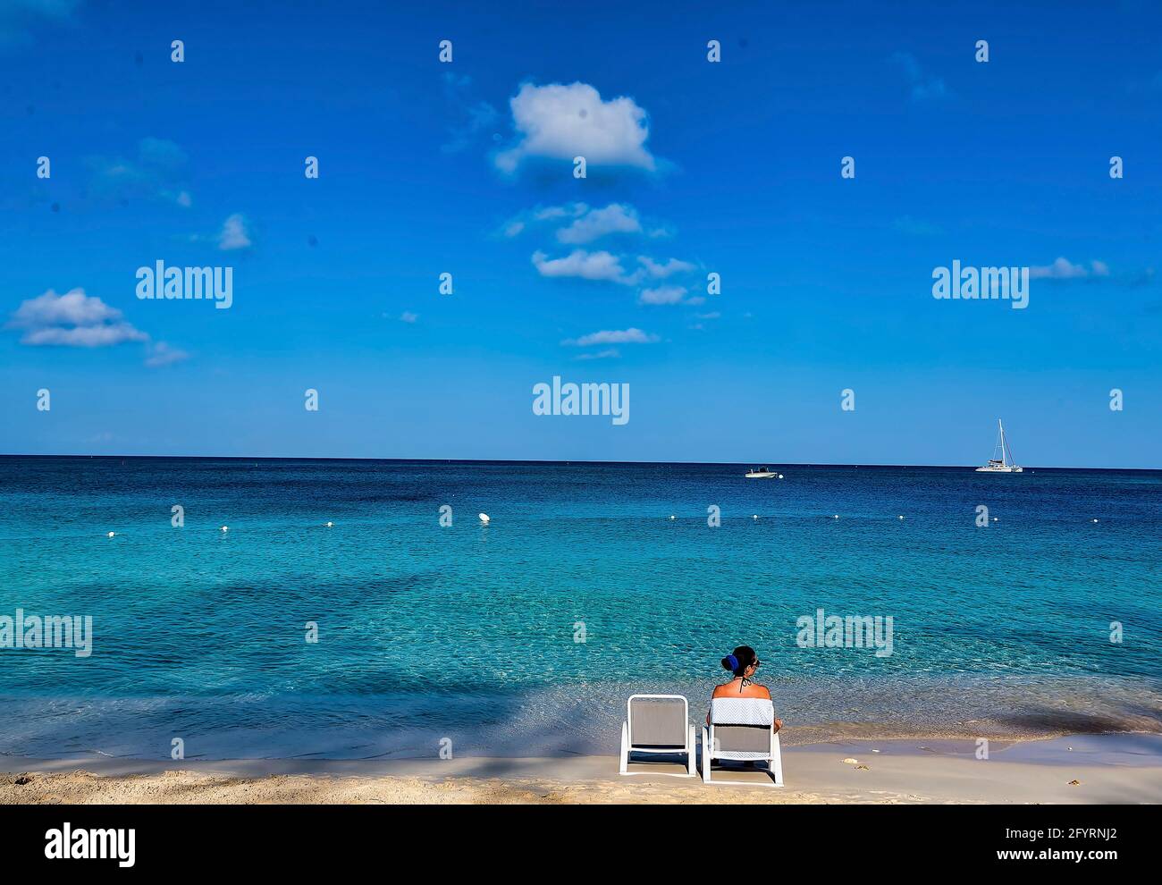 Relaxing on Seven Mile Beach, Grand Cayman Island. Stock Photo