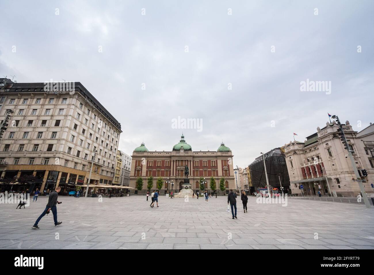 BELGRADE, SERBIA - JUNE 21, 2020: Speople rushing on Trg Republike in the afternoon with Prince Mihailo (Knez Mihailo) statue and National Museum,  wh Stock Photo