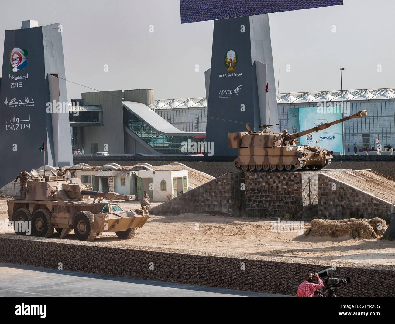 Abu Dhabi, UAE - Feb.20.2013: South African G6 Rhino mine-protected self-propelled 155mm howitzer and M-109 A1 155mm self-propelled gun in IDEX 2013 m Stock Photo