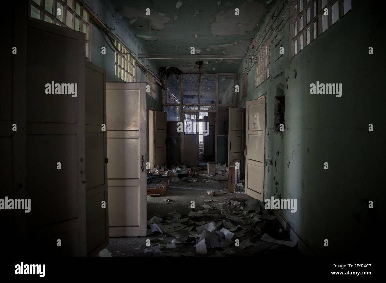 Picture of a damaged interior of an abandoned office building with a