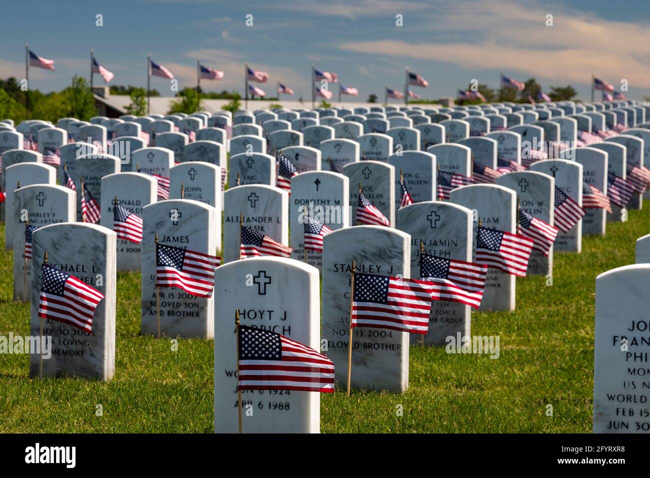 Holly, Michigan, USA. 29th May, 2021. American flags were placed on the graves of veterans for Memorial Day at Great Lakes National Cemetery. Credit: Jim West/Alamy Live News Stock Photo