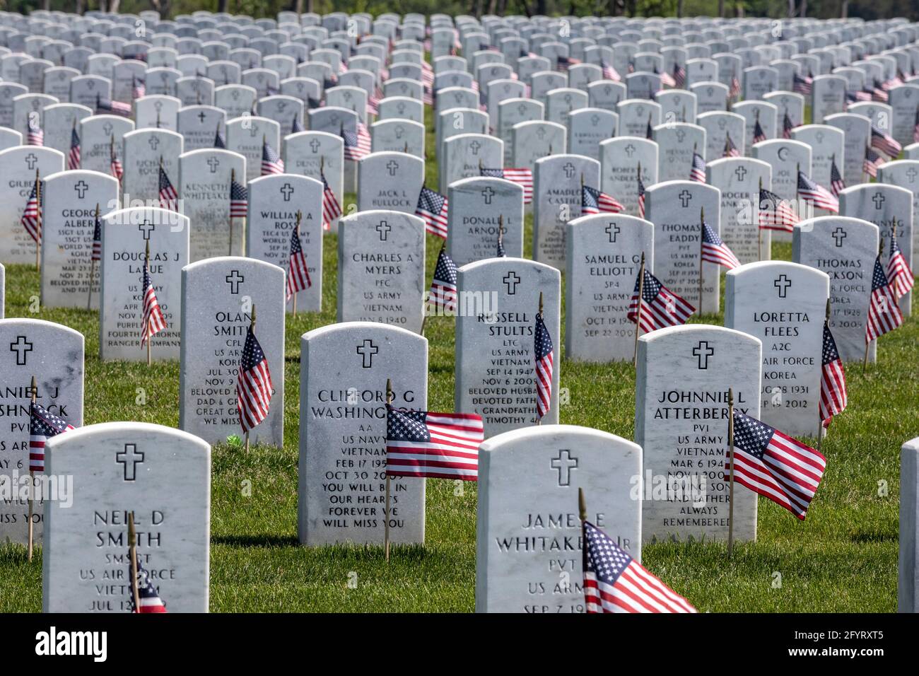 Holly, Michigan, USA. 29th May, 2021. American flags were placed on the graves of veterans for Memorial Day at Great Lakes National Cemetery. Credit: Jim West/Alamy Live News Stock Photo
