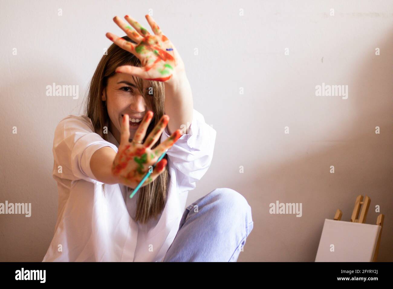 A cute artistic female showing her palms in paint Stock Photo - Alamy