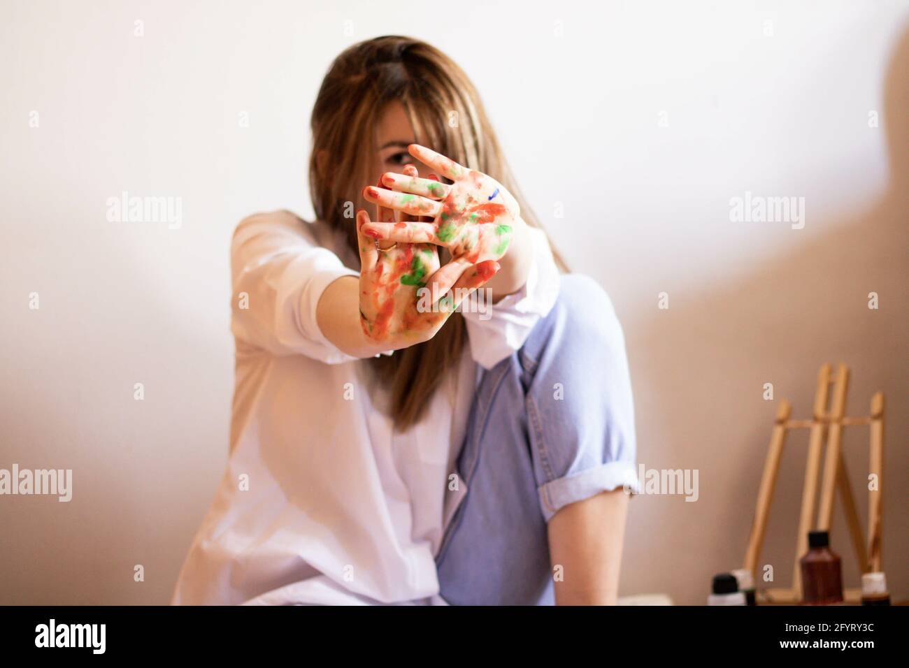 A cute artistic female showing her palms in paint Stock Photo - Alamy