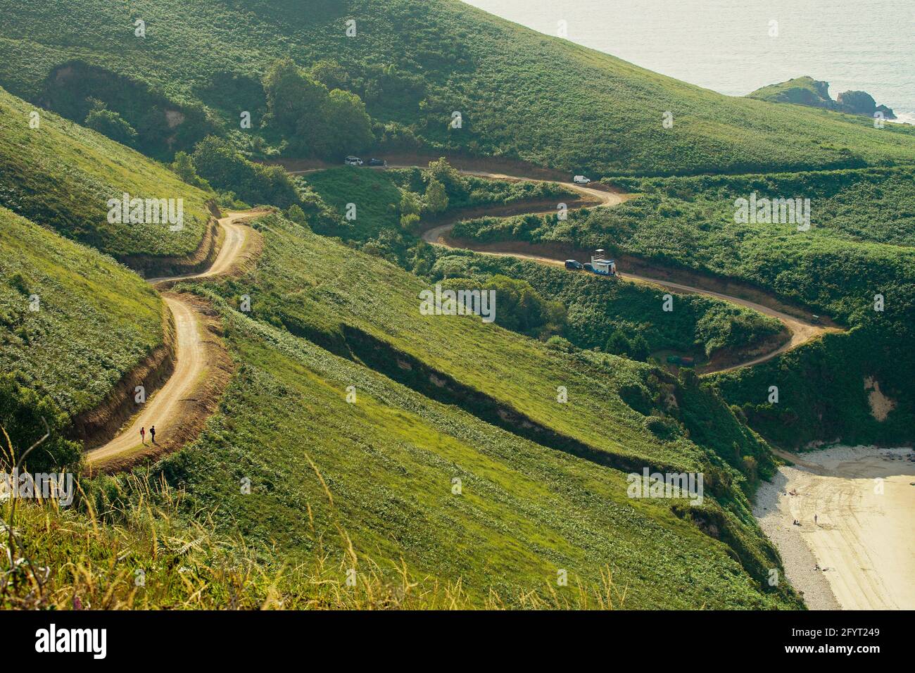 An aerial view of a zigzag road on the green mountains Stock Photo Alamy