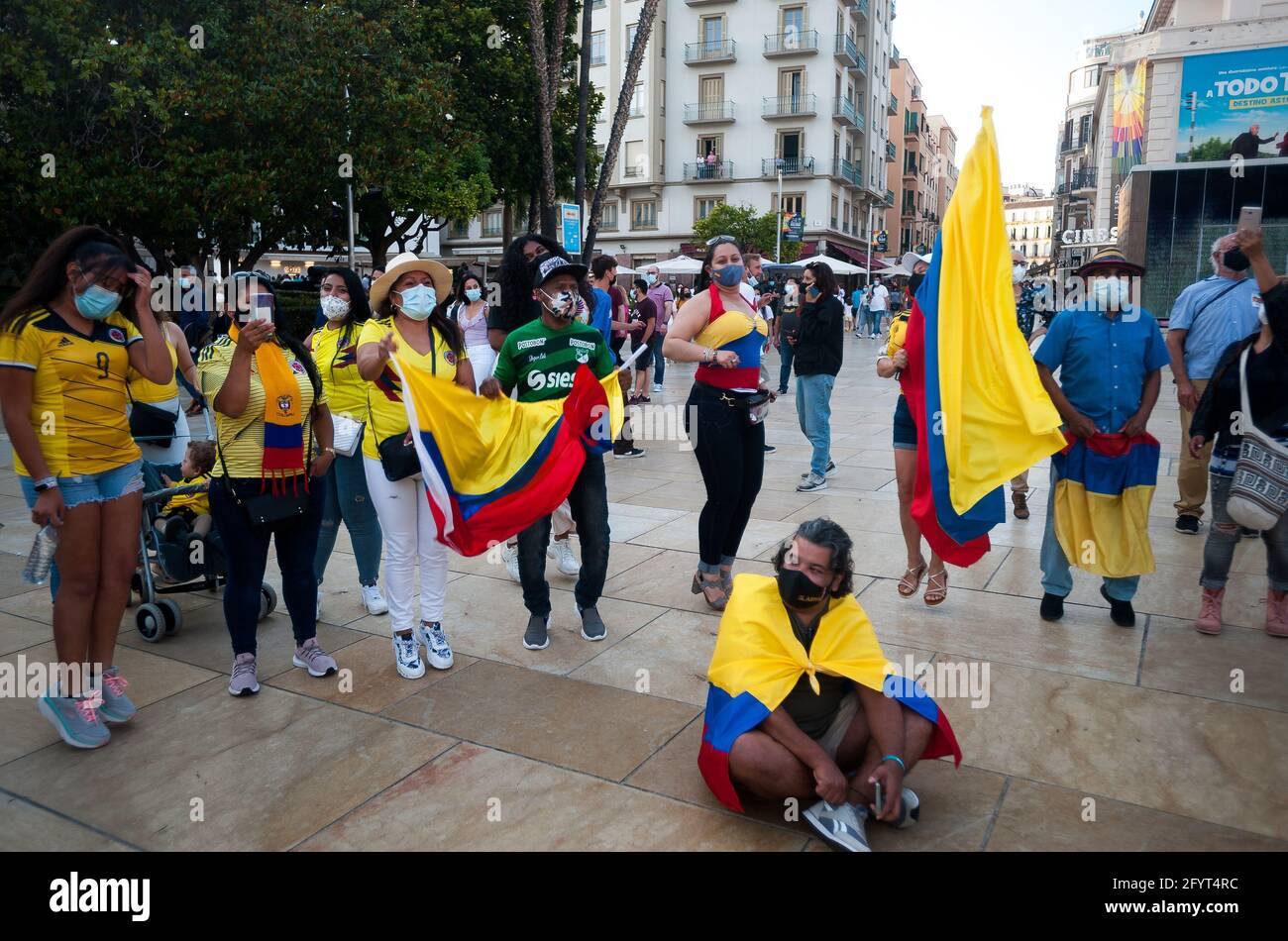 Malaga, Spain. 29th May, 2021. Colombian protesters are seen holding flags as they dance during a protest on Alcazabilla street.After a month of protests following the social burst in Colombia, dozens of Colombians living in Malaga showing again their solidarity with the Colombian population and against the violence of the government of President Iván Duque. Credit: SOPA Images Limited/Alamy Live News Stock Photo