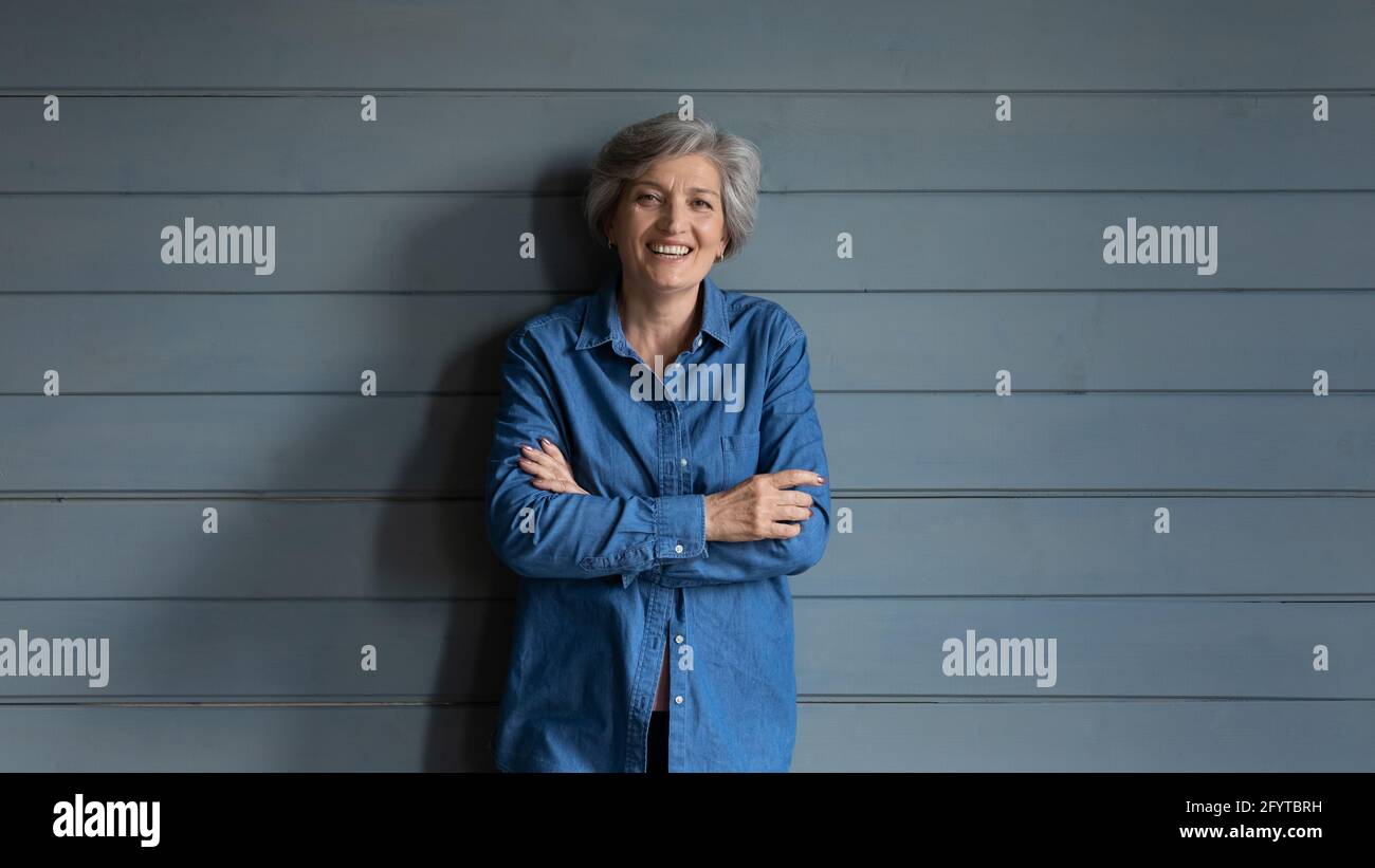 Half-length portrait old grey haired woman posing in studio Stock Photo