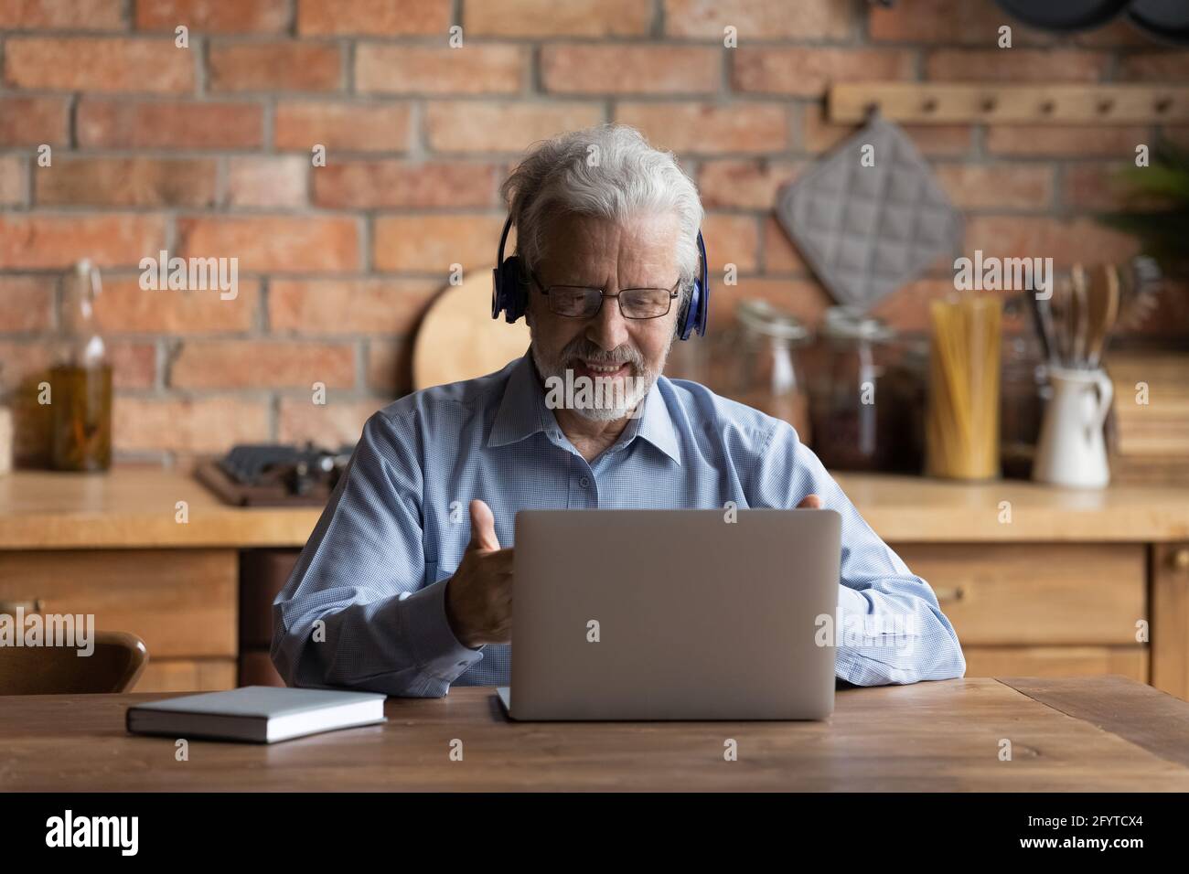 Older patient receive online counselling use laptop and videocall app Stock Photo