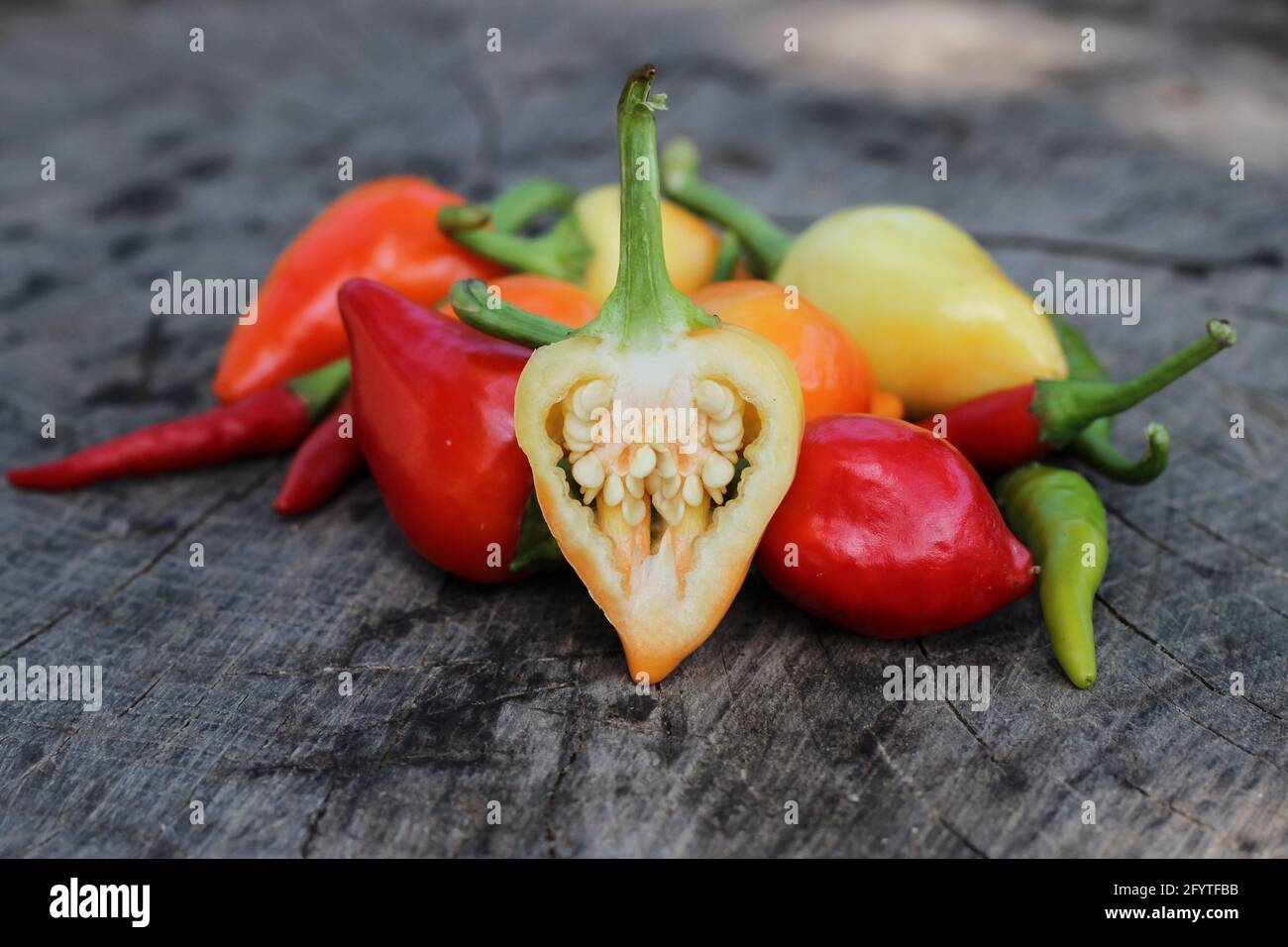 Chili peppers on wooden background Stock Photo - Alamy