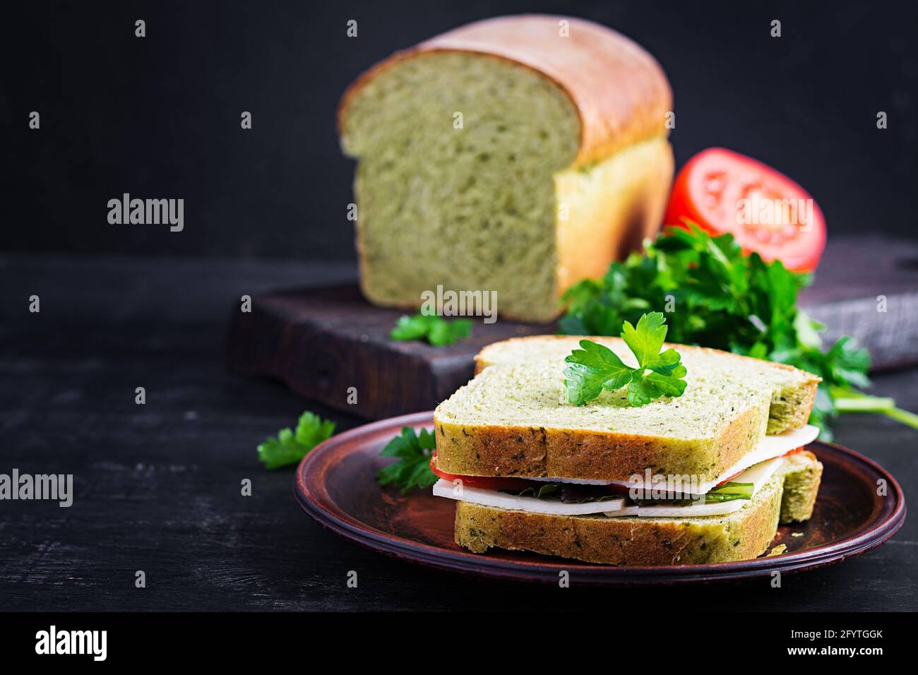 Spinach bread and a sandwich with cheese, tomatoes and herbs. Healthy