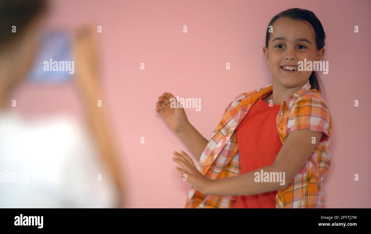 Surprised little girl. Isolate on pink background Stock Photo - Alamy