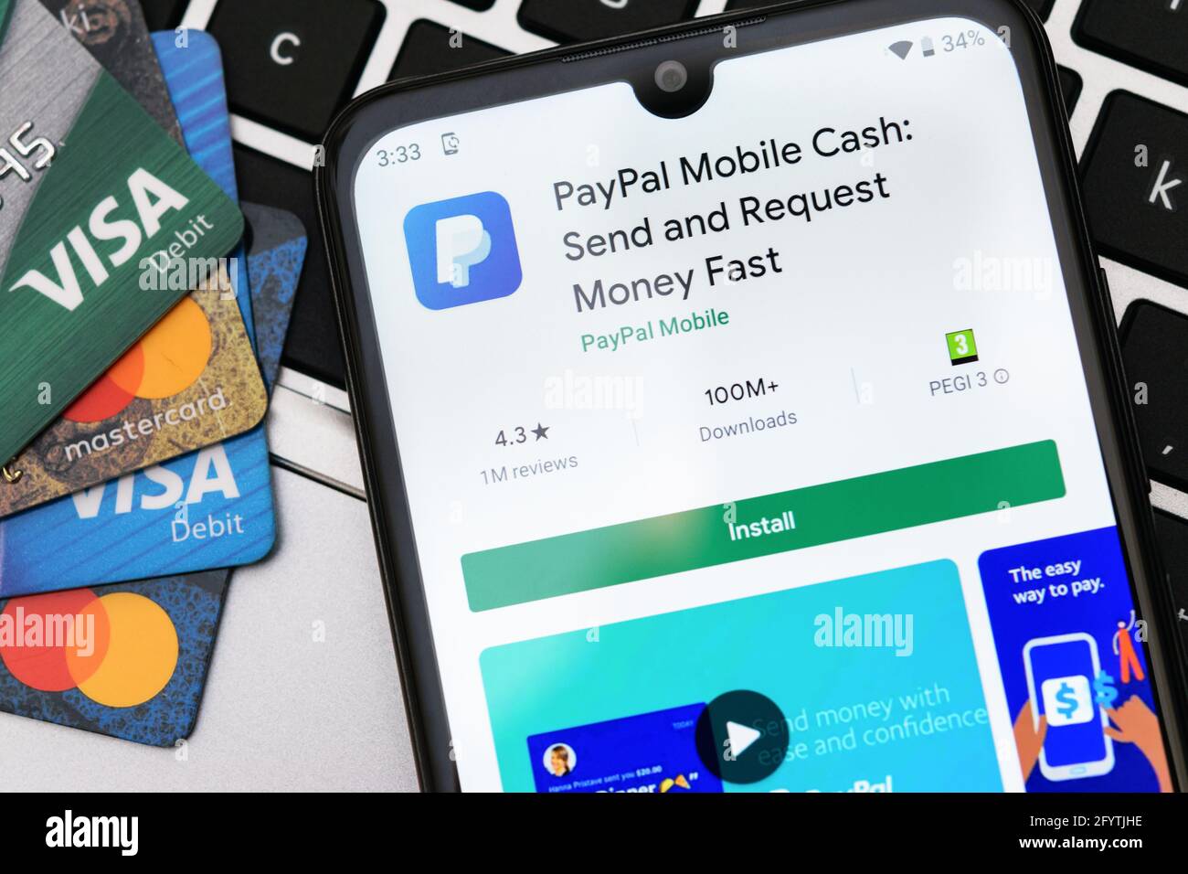 Krakow, Poland - September 30, 2020:  PayPal application  in Google Play store next to Visa and Mastercard cards. PayPal is an online electronic finan Stock Photo