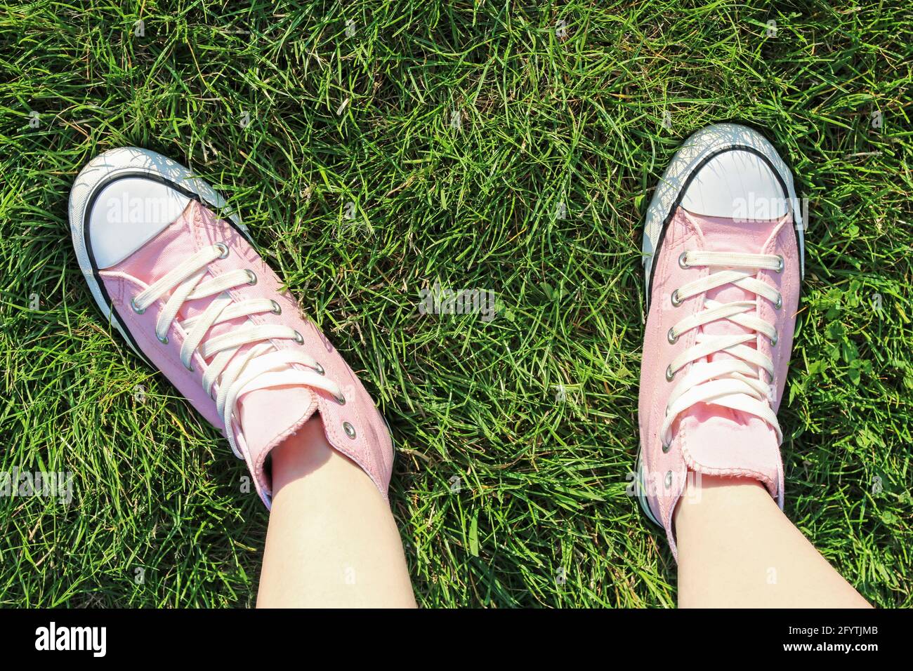 Pink trainers on grass. Graphic resources Stock Photo - Alamy