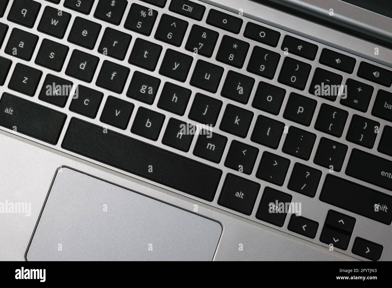Top view of a silver and black notebook keyboard in close-up Stock Photo