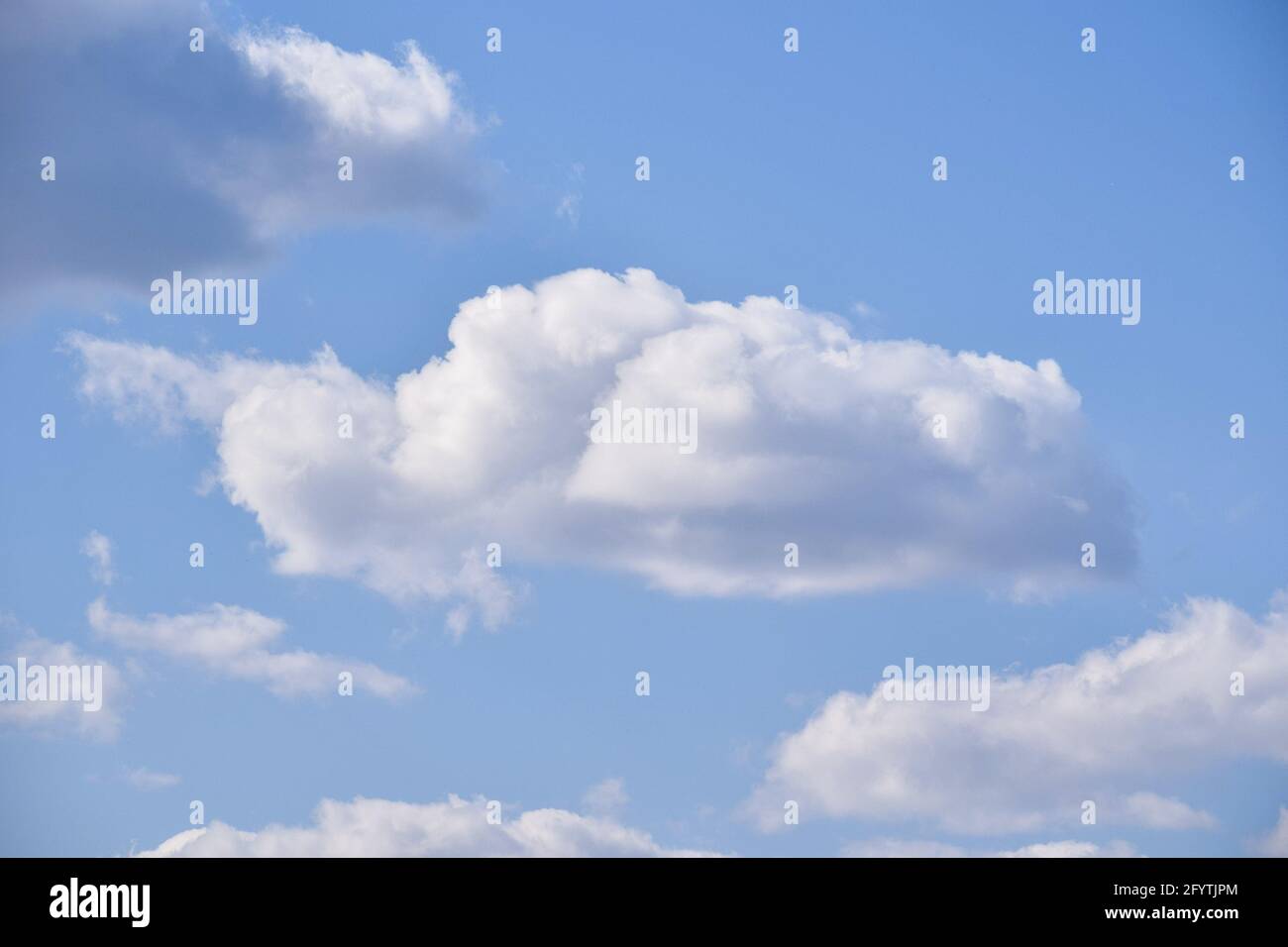 A low angle shot of the beautiful and fluffy clouds in the blue sky ...