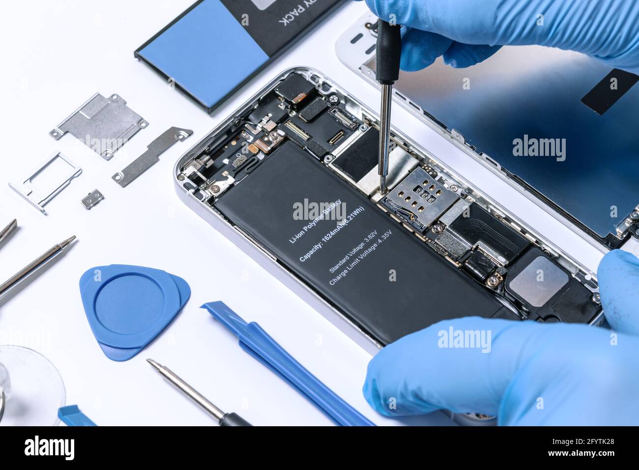 Professional occupation services concept - technician or engineer is repairing modern smartphone motherboard in a professional laboratory. Stock Photo