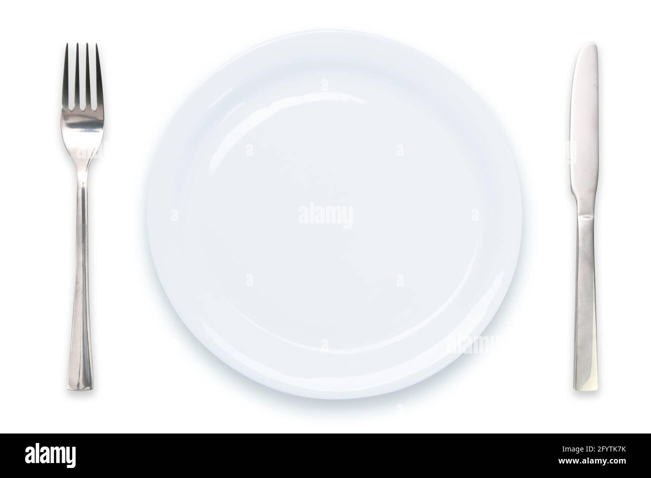 Cooking template - top view of an empty white plate with knife and fork isolated on a white background Stock Photo