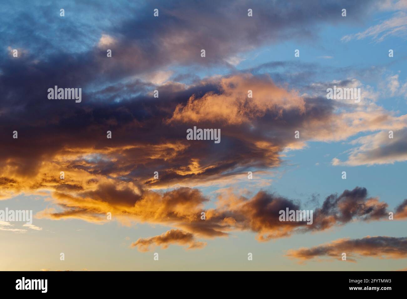The setting sun lighting up the cloud cover Stock Photo