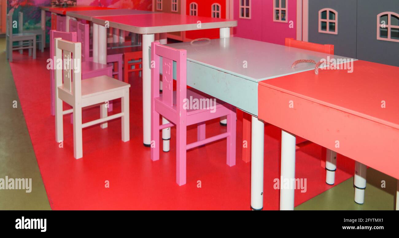 A set of cute children's tables and high chairs in the kindergarten