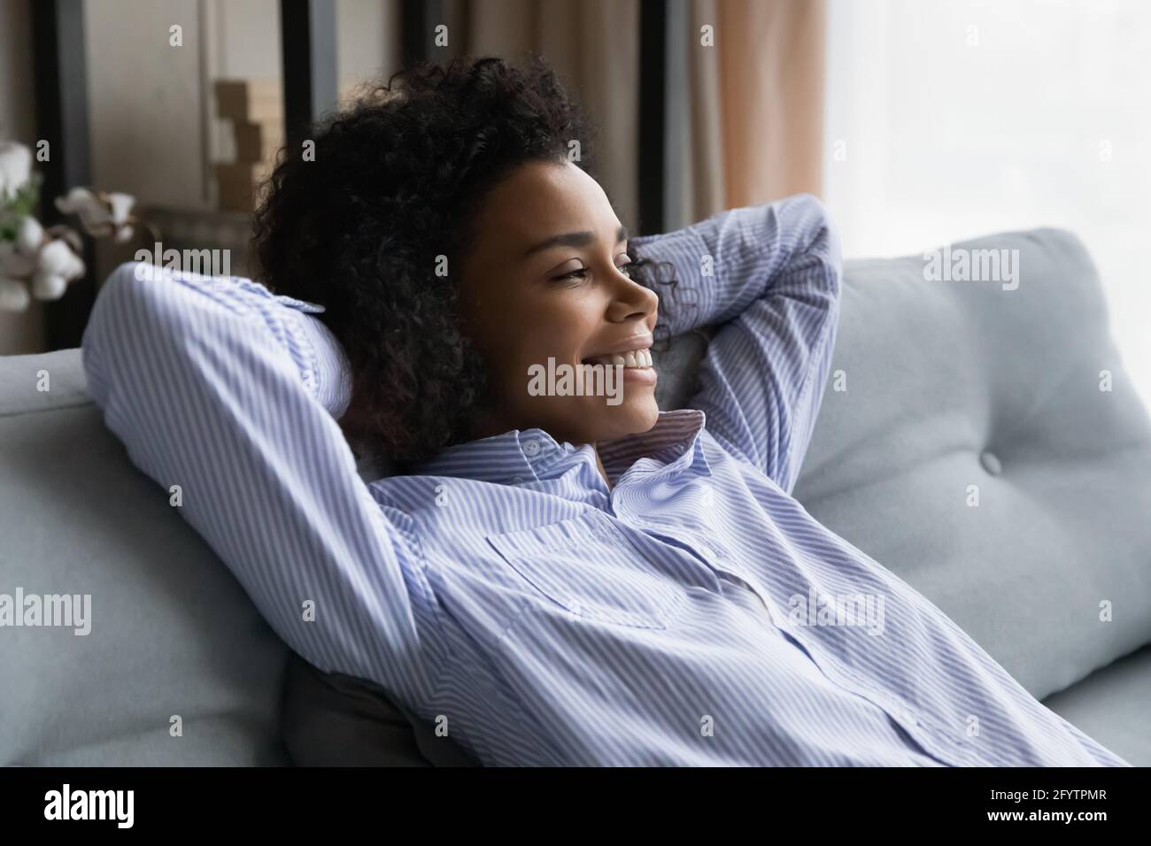 Smiling African American woman look in distance dreaming Stock Photo ...