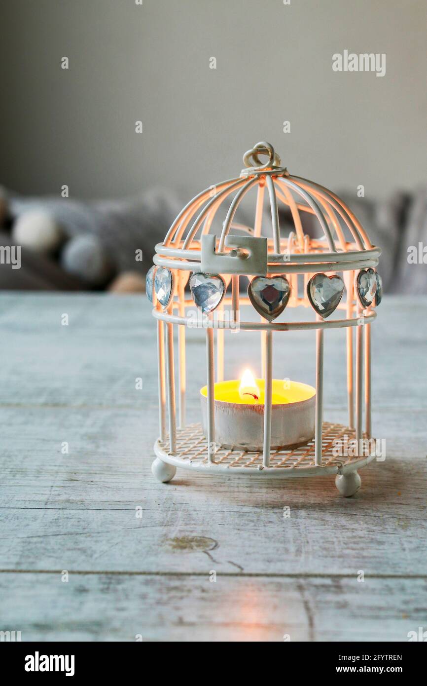 Small white lantern on the table in grey room. Party decor Stock Photo