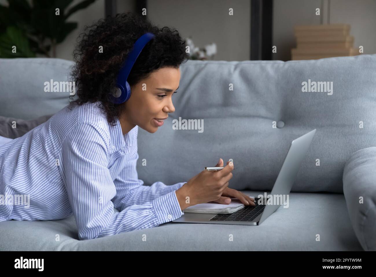 Biracial female student study on laptop at home Stock Photo