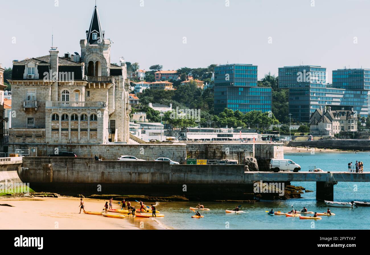 Ribeira beach in Cascais, Portugal with people enjoying the sunny