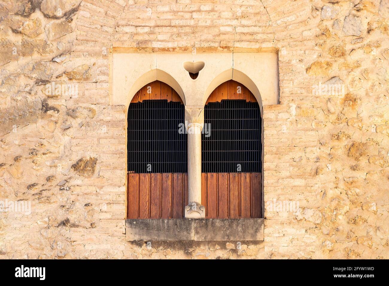 Old windows on brown stone wall for texture Stock Photo - Alamy