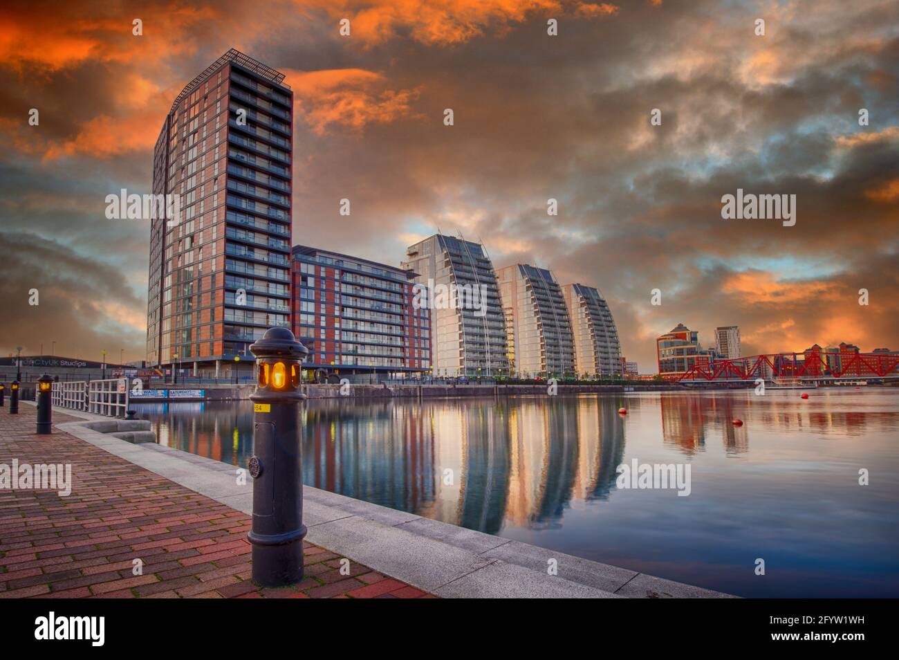The sun setting over the NV Buildings and one of the docks at Salford Quays, Salford, Lancashire, UK Stock Photo