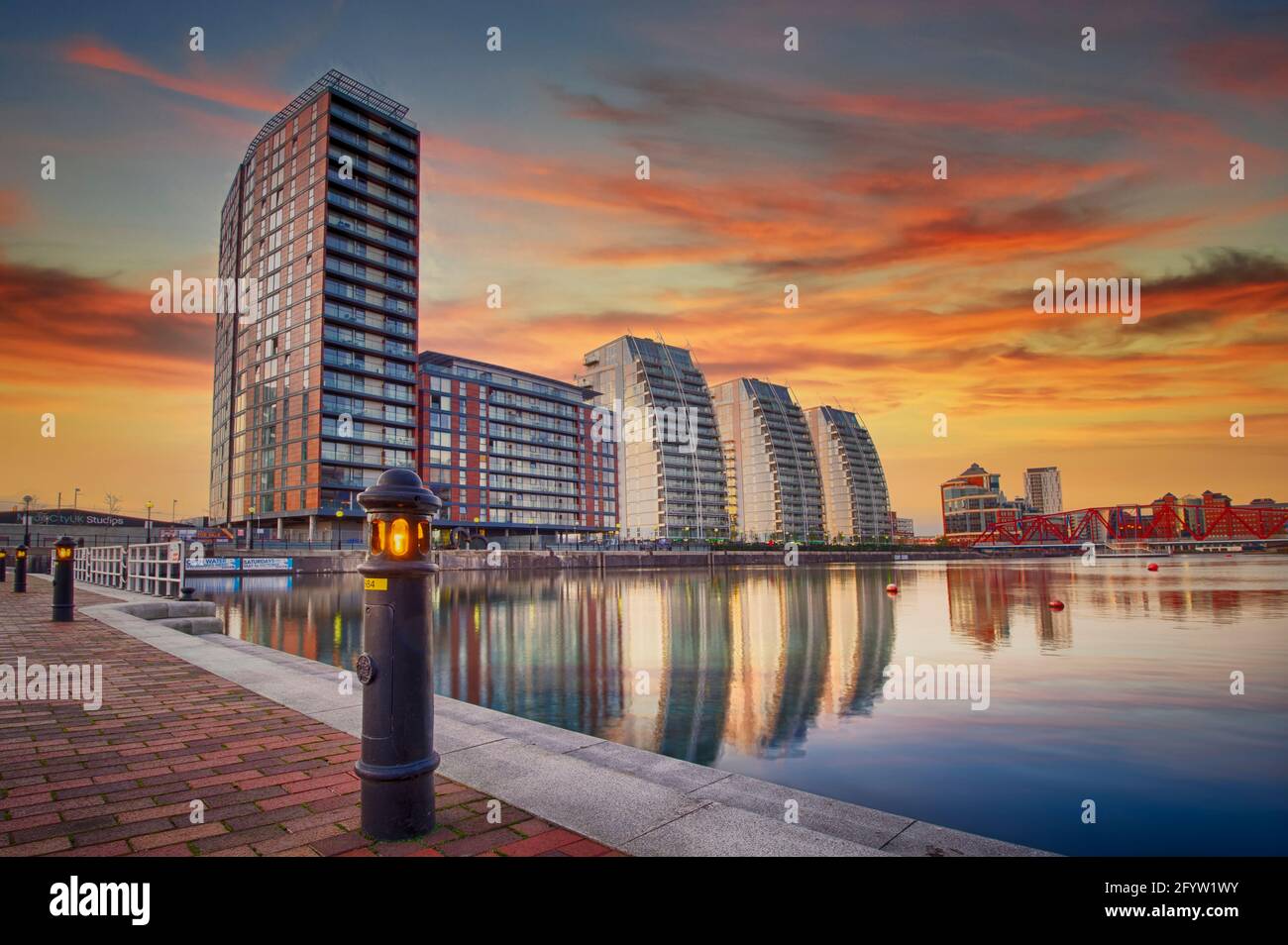 The sun setting over the NV Buildings and one of the docks at Salford Quays, Salford, Lancashire, UK Stock Photo
