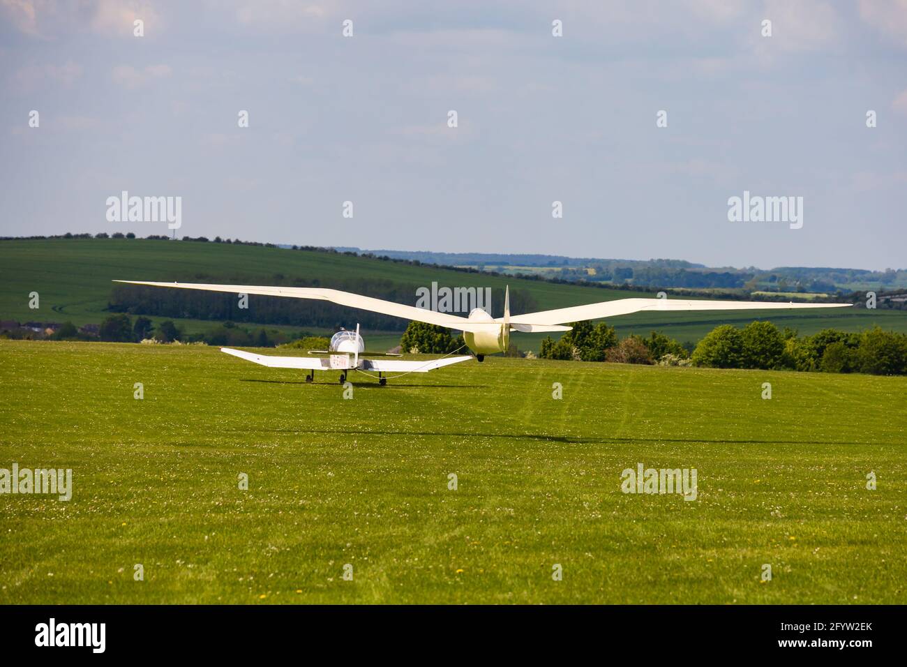 Vintage Goppingen Minimoa glider on aerotow behind a Robin tug.  at the London Gliding Club, based at Dunstable, Bedfordshire, England Stock Photo