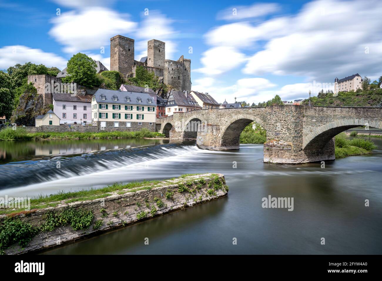 river Lahn in Runkel, Germany with old stone bridge and castle (taken with neutral-density filter) Stock Photo