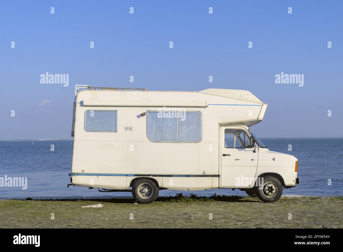 Vintage camper van parked by the riverfront Stock Photo - Alamy