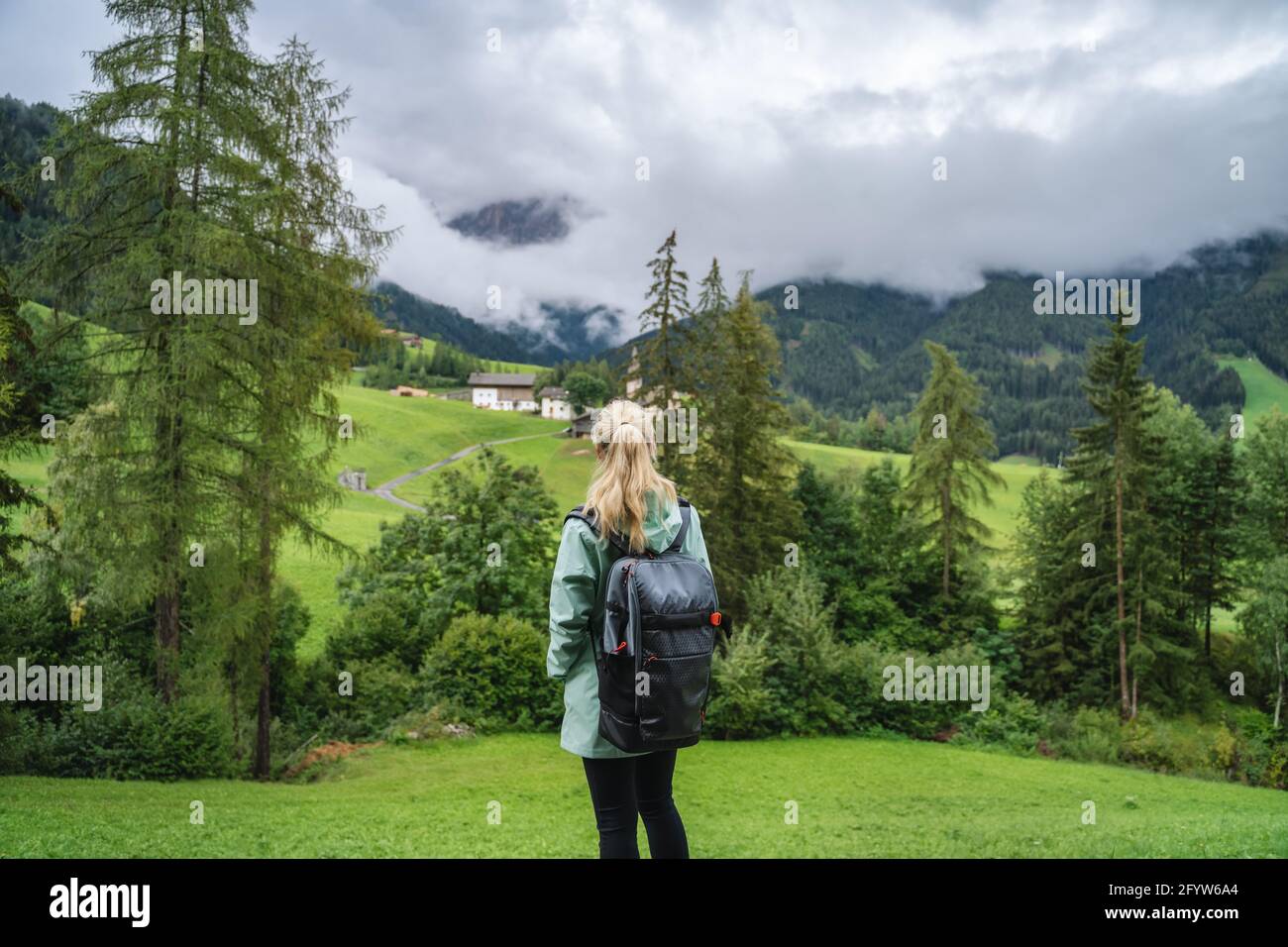 Woman enjoy the view of Val di Funes valley in the Dolomites, Santa Maddalena touristic village, Dolomites, Italy, Europe Stock Photo