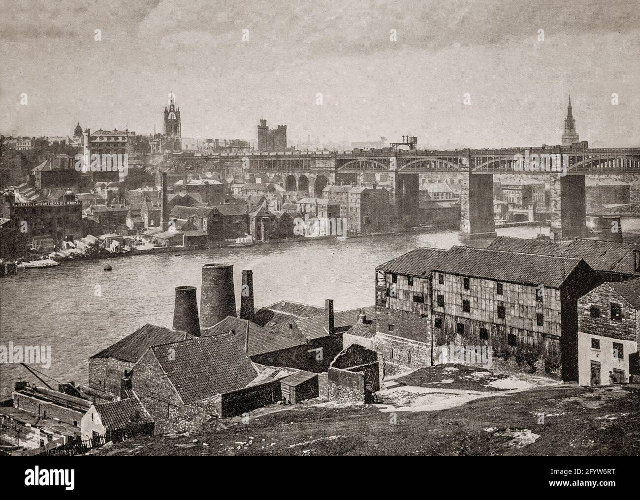 A late 19th century view of the High Level Bridge, a road and railway bridge spanning the River Tyne between Newcastle upon Tyne and Gateshead in North East England. It was designed by Robert Stephenson to form a rail link towards Scotland for the developing English railway network and officially opened by Queen Victoria in 1849. The castle and cathdral can be seen on the skyline. Stock Photo