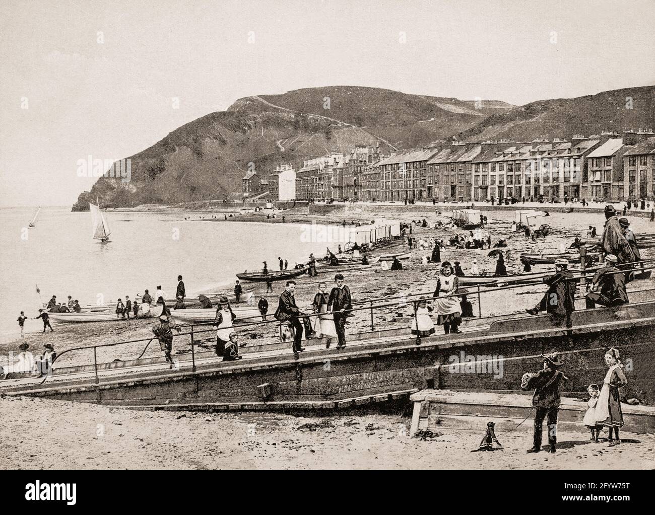 A late 19th century view of the beach Aberystwyth, a university town in Ceredigion, Wales. Historically in the historic county of Cardiganshire, in one form or another, Aberystwyth University has been a major educational location in Wales since the establishment of University College Wales in 1872. The arrival of the railway around 1870 gave rise to something of a Victorian tourist boom; the town was once even billed as the 'Biarritz of Wales'. Stock Photo
