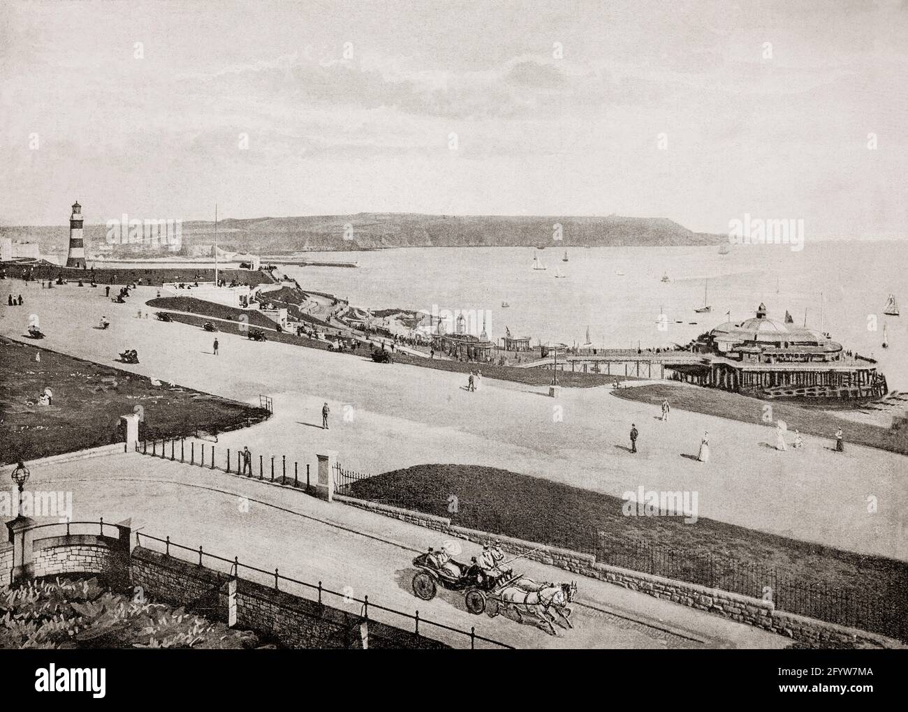 A late 19th century view of the Hoe in Plymouth, a port city in Devon on the south coast of England, where Sir Francis Drake seemingly insisted on completing his game of bowls before engaging the Spanish Armada in 1588. The grand pleasure pier, started in 1880, provided a dance hall, refreshments, promenade and a landing place for boat trips, but it was bombed in World War II. Left is John Smeaton's Eddystone Lighthouse. Originally built in 1759 on the Eddystone Rocks, 14 miles to the south, it was dismantled in 1877 and moved  to the Hoe where it was re-erected. Stock Photo