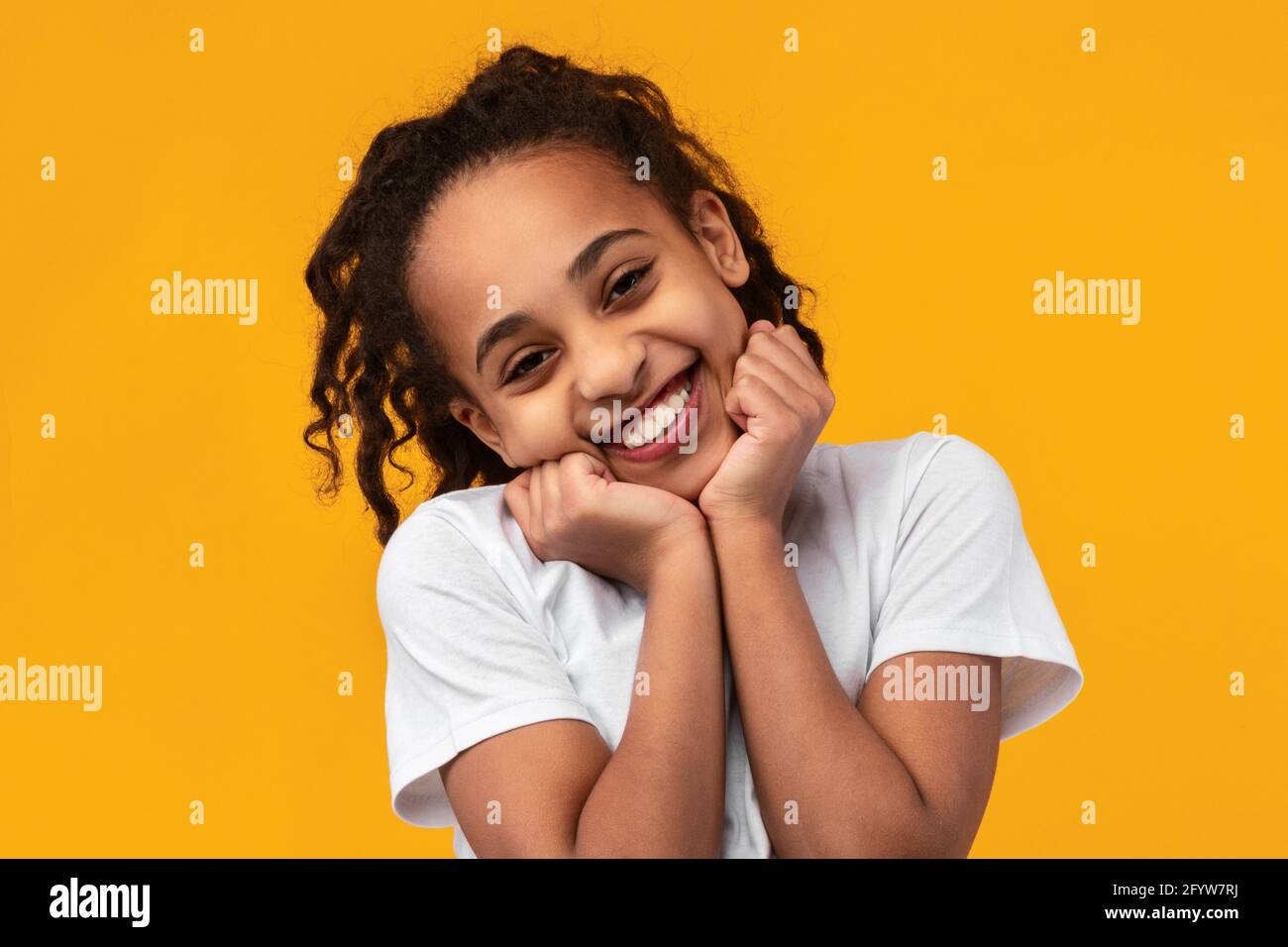 Cute Joyful African American Girl Touching Cheeks Stock Photo - Alamy