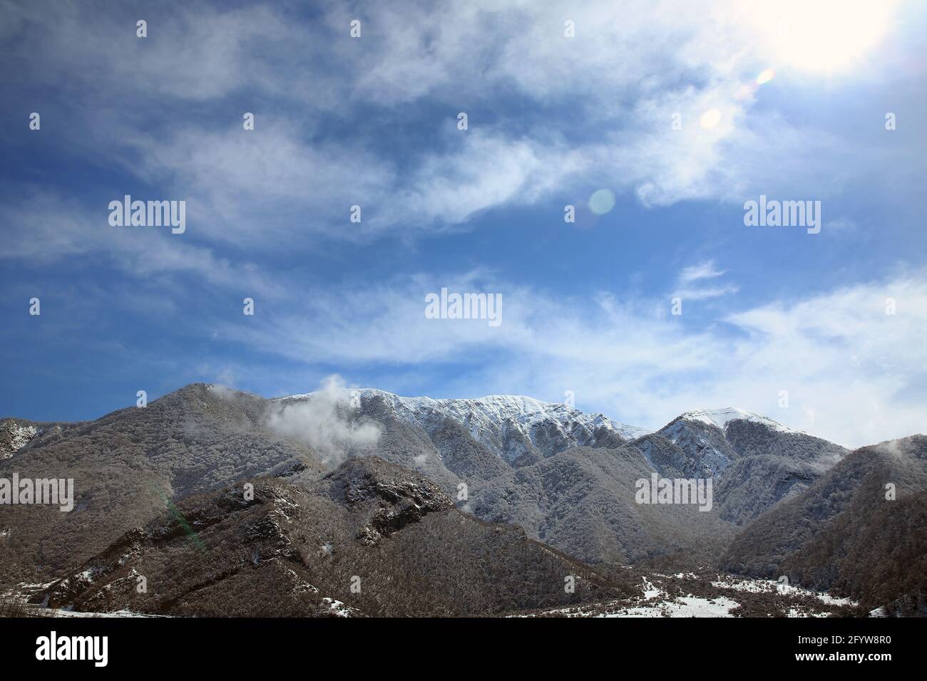 It snowed in the village . The leaves of the trees fell on the mountain . It snowed in the mountains and in the village . Bash Dashagil village of Ogu Stock Photo