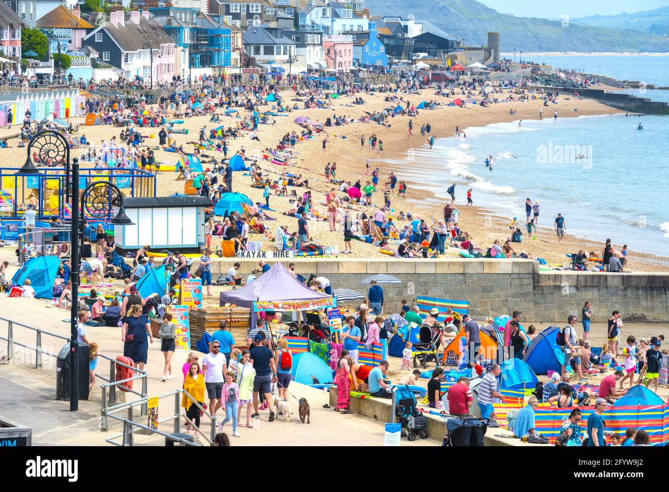 Lyme Regis, Dorset, UK. 30th May, 2021. UK Weather. Beaches and car parks are packed at the seaside resort of Lyme Regis on the bank holiday weekend as visitors flock to the beach to enjoy scorching hot sunsine as the heatwave continues. Credit: Celia McMahon/Alamy Live News Stock Photo