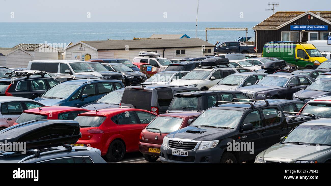 Lyme Regis, Dorset, UK. 30th May, 2021. UK Weather. The car parks at Lyme Regis were packed to capacity as peopled flocked to the beach to enjoy scorching hot sunsine as the heatwave continues. Credit: Celia McMahon/Alamy Live News Stock Photo