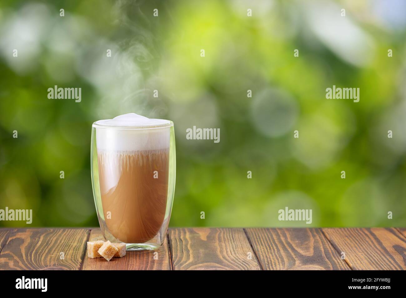 cappuccino in glass with double walls on table Stock Photo