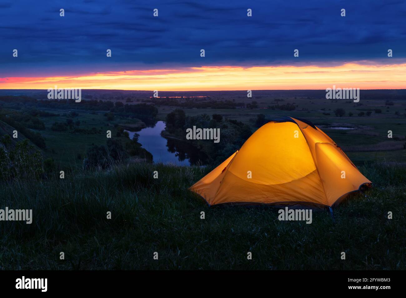 tourist tent on the hill near the river Stock Photo - Alamy