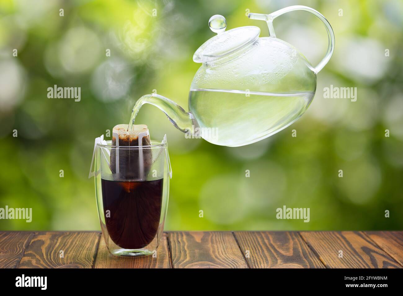 hand drip coffee in glass on wooden table Stock Photo