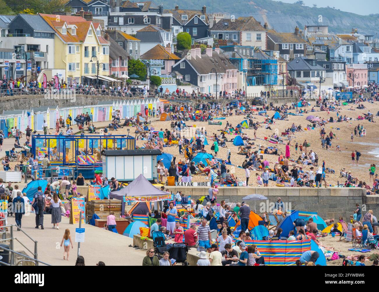 Lyme Regis, Dorset, UK. 30th May, 2021. UK Weather. Beaches and car parks are packed at the seaside resort of Lyme Regis on the bank holiday weekend as visitors flock to the beach to enjoy scorching hot sunsine as the heatwave continues. Credit: Celia McMahon/Alamy Live News Stock Photo