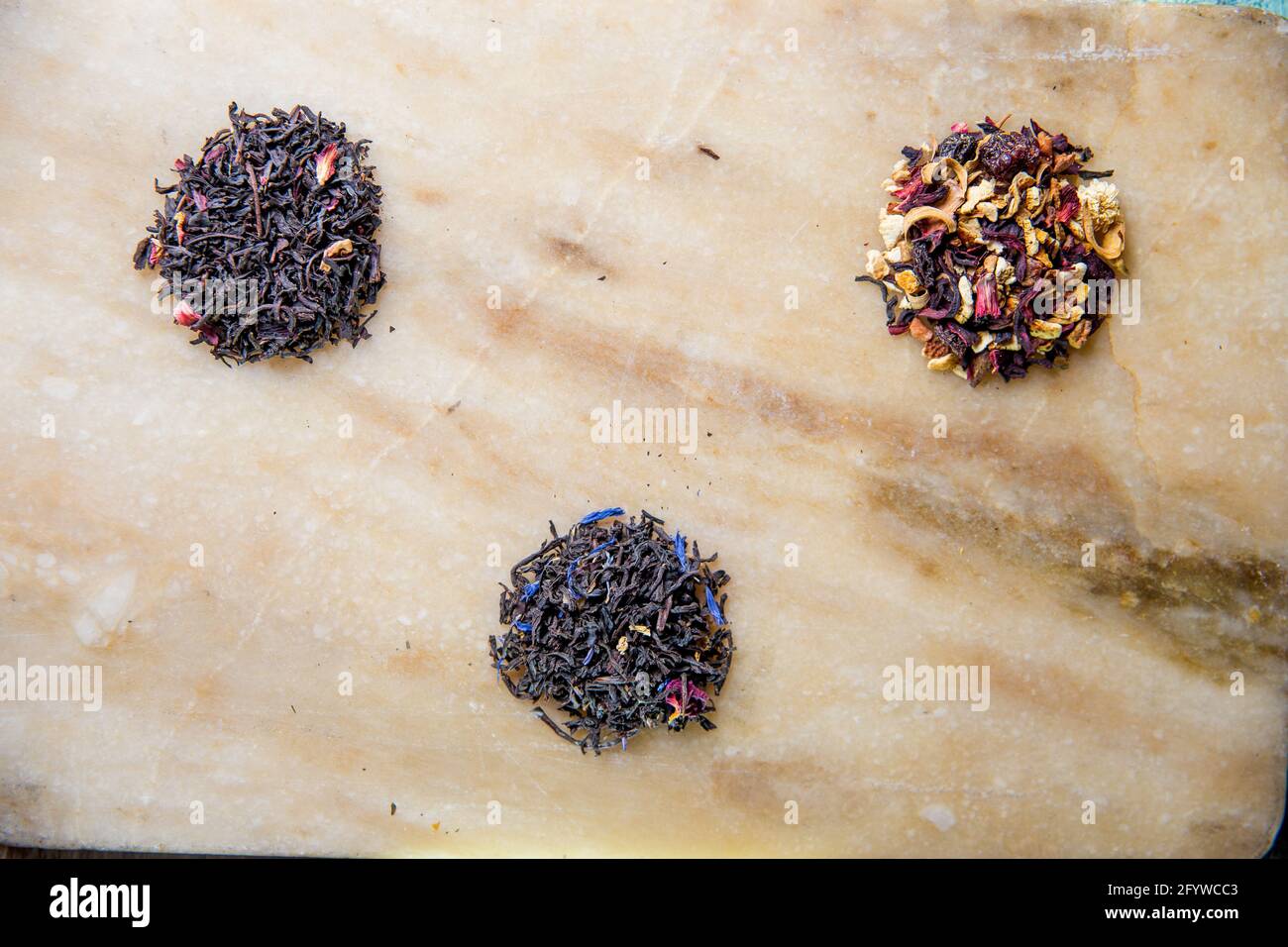assorted sheet tea black fruit on a marble board. Stock Photo