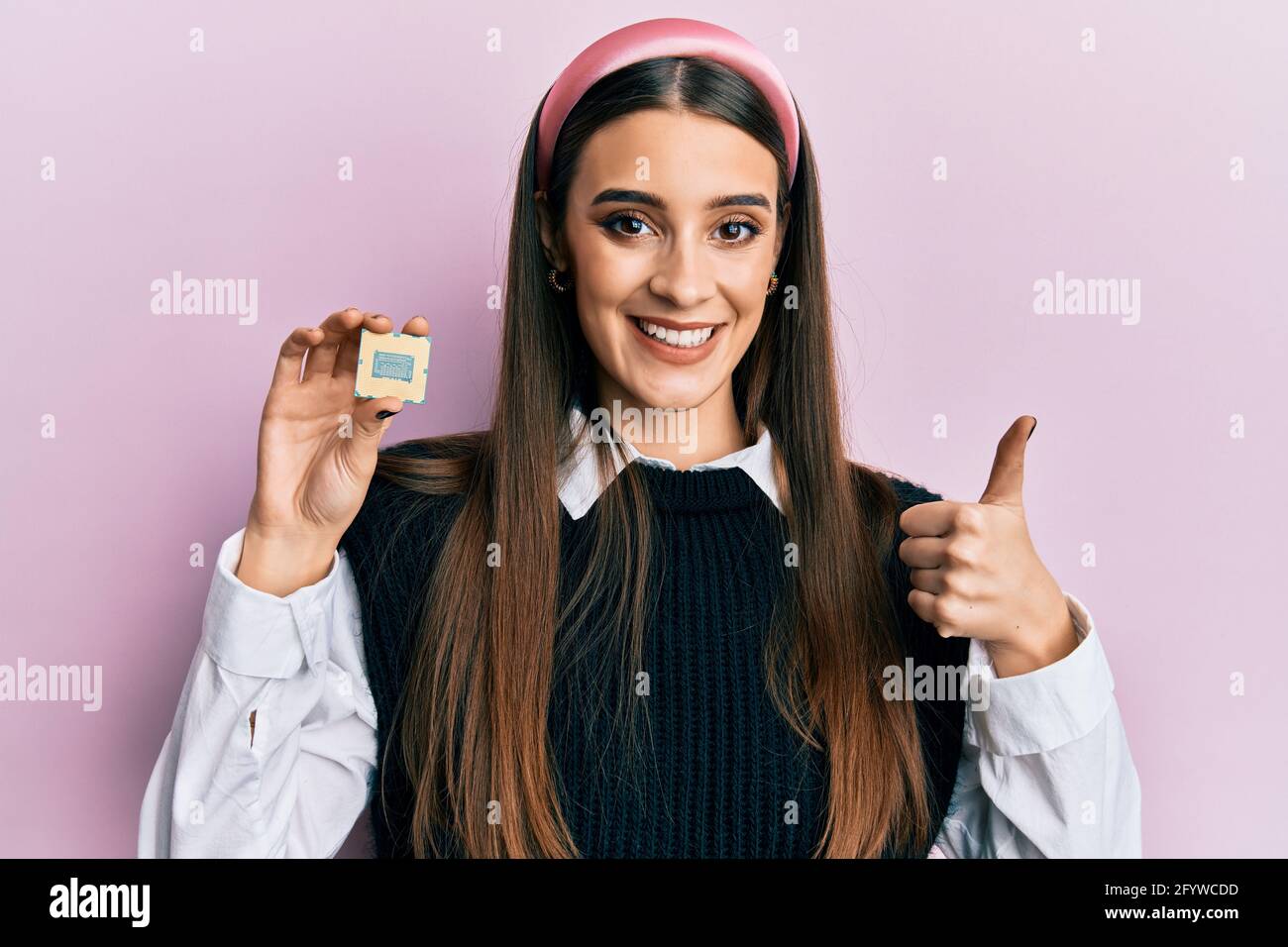 Beautiful brunette young woman holding cpu processor computer smiling ...